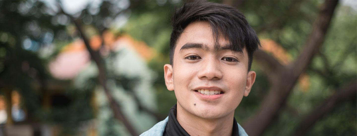 Male outside wearing necklace