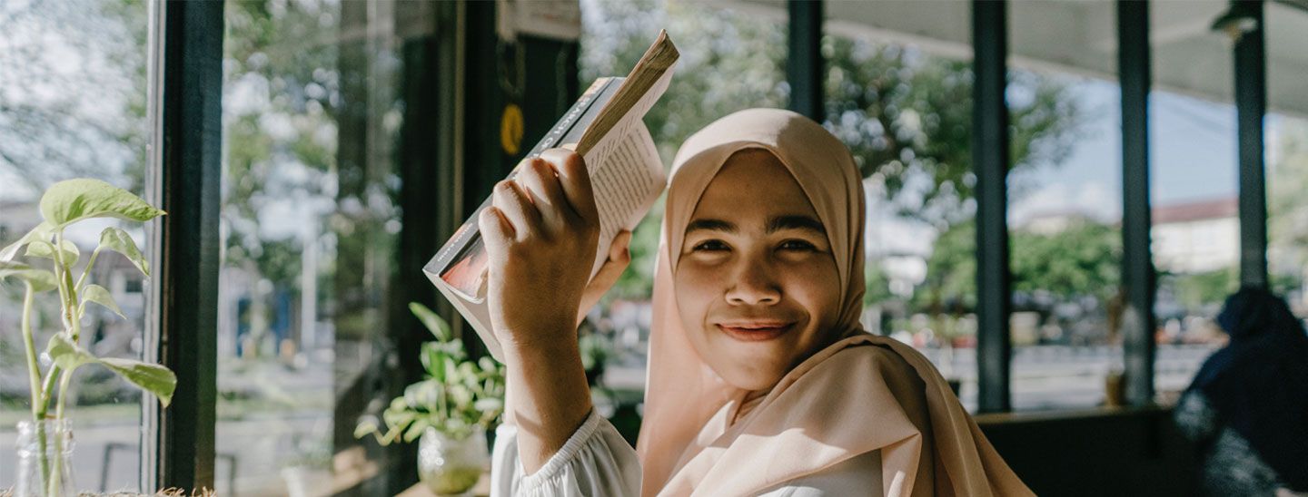 Student sitting inside reading