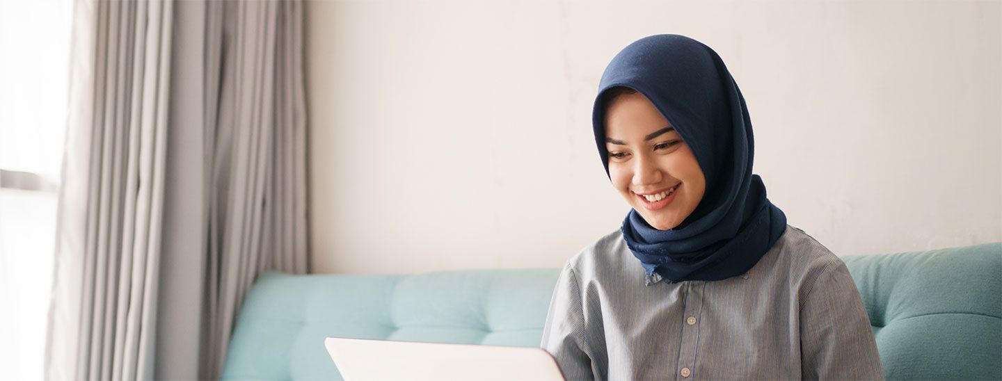 Student alone inside using laptop