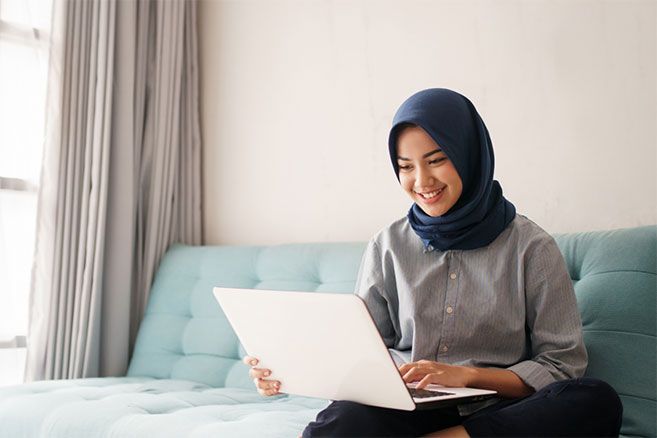 Student alone inside using laptop